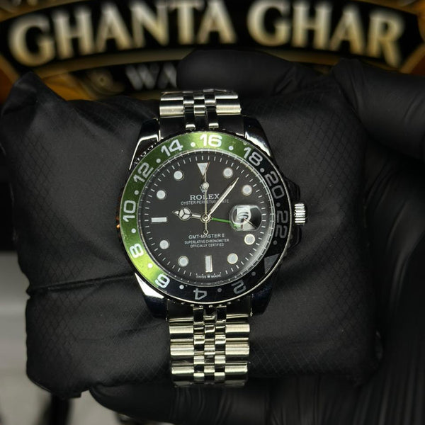 Rolex watch with green bezel held by a gloved hand in front of 'Ghanta Ghar' sign.